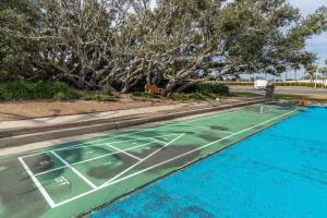 a tennis court is next to a swimming pool at Phoenix East 1211 in Orange Beach