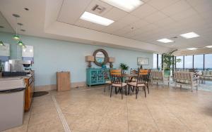 a restaurant with a table and chairs in a room at Phoenix East 1211 in Orange Beach