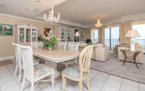 a dining room and living room with a table and chairs at Phoenix East 1401 in Orange Beach