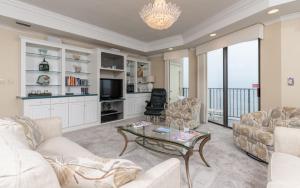 a living room with a couch and a coffee table at Phoenix East 1401 in Orange Beach