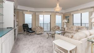 a living room with a couch and a table at Phoenix East 1401 in Orange Beach