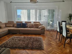 a living room with a couch and a table at FAMILLE Apartman in Tapolca +37 photos
