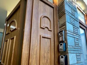 a wooden door with a wall with a brick at VASKO Luxury Suites 4 in Siátista
