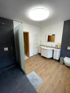 een badkamer met douche, wastafel en toilet bij Pension Zum Waldrand in Sinsheim