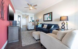 a living room with a couch and a tv at Phoenix East 1405 in Orange Beach