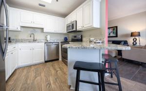 a kitchen with white cabinets and a counter top at Phoenix East 1405 in Orange Beach
