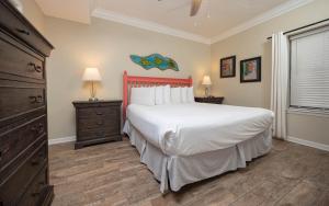 a bedroom with a large white bed and a window at Phoenix East 1405 in Orange Beach +41 photos