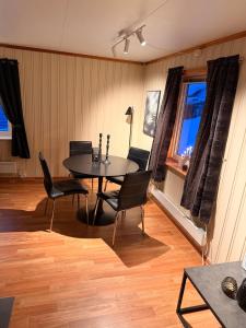 a dining room with a table and chairs at Senja, Botnhamn in Senja