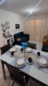 a dining room table with plates and dishes on it at Pedacinho de Lar in João Pessoa +12 photos
