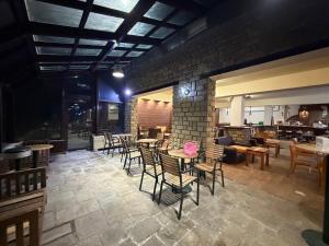 a restaurant with chairs and tables and a brick wall at Chalet Vasilitsa in Grevena