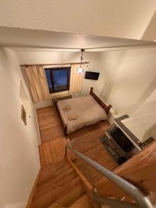 an overhead view of a room with a bed and stairs at Chalet Vasilitsa in Grevena +12 photos