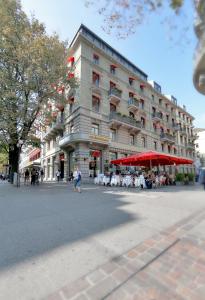 a large building with tables and chairs in front of it at Hotel St.Gotthard in Zürich