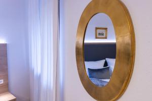 a gold mirror on a wall in a room at Schloss Höfingen in Leonberg