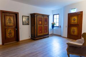 a living room with a large cabinet and a table at Schloss Höfingen in Leonberg