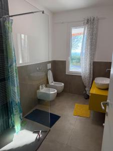 a bathroom with a toilet and a glass shower at Villetta Brasi in Celle Ligure +26 photos