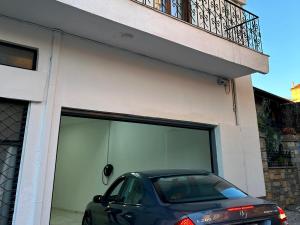a car parked in front of a garage at VASKO Luxury Suites 3 in Siátista
