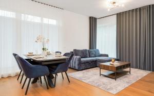 a living room with a table and a couch at Lodja Suites in Tartu