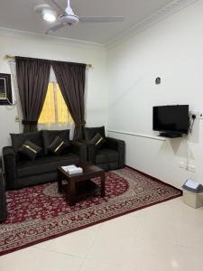 a living room with a couch and a coffee table at شقة مفروشة بحي النسيم in Mecca