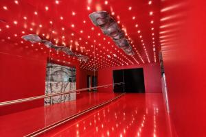 a red room with lights on the ceiling at BA Millenium in Buenos Aires