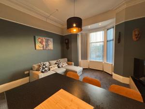 a living room with a table and a couch at Louise Suite in Southport