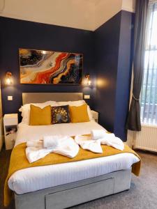 a bedroom with a bed with towels on it at Louise Suite in Southport