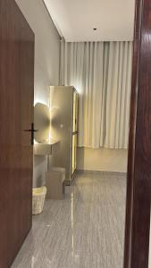 een lege kamer met een koelkast en een raam bij شقه بصالة وغرفتين نوم in Hafr Al Baten