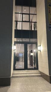 een groot gebouw met glazen ramen en een trap bij شقه بصالة وغرفتين نوم in Hafr Al Baten
