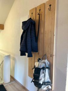 a blue jacket hanging on a wall next to a bag at Alpenheimat 1658 in Mittelberg