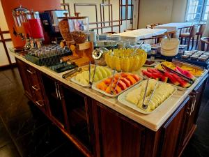 a buffet with different types of food on a table at Hotel Santoni in Guarapuava