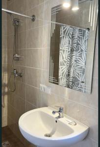 a bathroom with a sink and a mirror at Hostel Гайсин in Haysyn