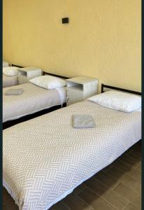 two beds sitting next to each other in a room at Hostel Гайсин in Haysyn
