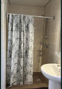 a shower curtain in a bathroom with a sink at Hostel Гайсин in Haysyn