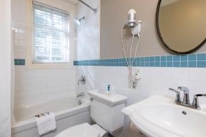 a bathroom with a toilet and a sink and a mirror at Sherwood Inn in Port Carling +96 photos