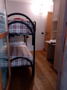 zwei Etagenbetten in einem kleinen Raum mit einer Theke in der Unterkunft Bernina House in Chiesa in Valmalenco