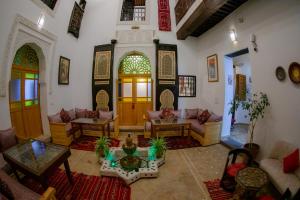 a living room with a couch and a table at Shauala Riad - Where History Lives in Fès