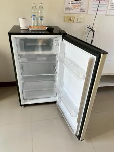 an empty refrigerator with its door open in a room at The Rich Home in Nakhon Ratchasima