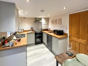 a kitchen with wooden counter tops and appliances at Tap Cottage in Burgh le Marsh