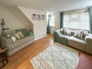 a living room with a couch and a table at Tap Cottage in Burgh le Marsh