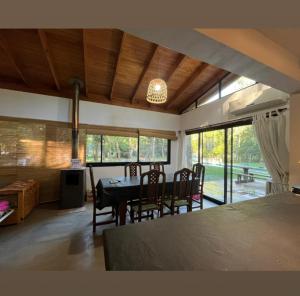 a living room with a table and chairs and a dining room at Quinta con pileta in Brandsen