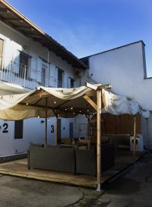 a patio with an umbrella and tables and chairs at IRIS - Spaziosa Casa Indipendente in Bergamo