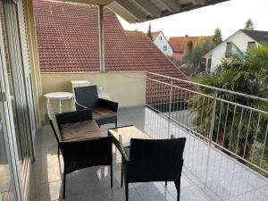 a balcony with chairs and a table on a balcony at Sunshine FeWo in Rust