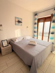 a bedroom with a bed and a window at Supramonte Guesthouse in Agropoli +19 photos