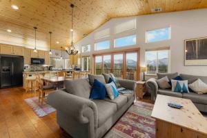 a living room with two couches and a kitchen at Lookout Point - Retreat for 6 in South Lake Tahoe