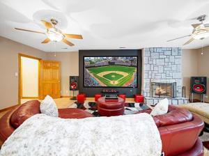 a living room with a couch and a tv at Beautiful home in Bridgeview! in Bridgeview