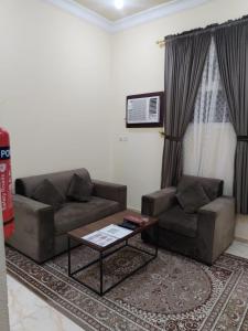 a living room with a couch and a coffee table at شقة مفروشة حائل in Hail