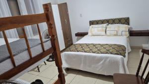 a bedroom with two bunk beds and a staircase at Apartmento 3 in Santa Vitória do Palmar