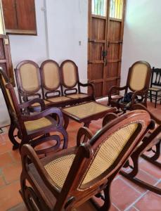 a group of chairs sitting in a room at Casa Faccioli in Mompos