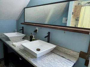 a bathroom with two sinks and a large mirror at Villa Gran Sasso in Hunter +15 photos