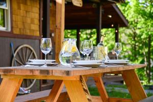 a wooden table with wine glasses and plates on it at 4 bedroom chalet in Hunter in Hunter