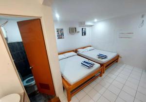 a small room with a bed and a bathroom at RenSea Haven Boracay Rm10 in Boracay